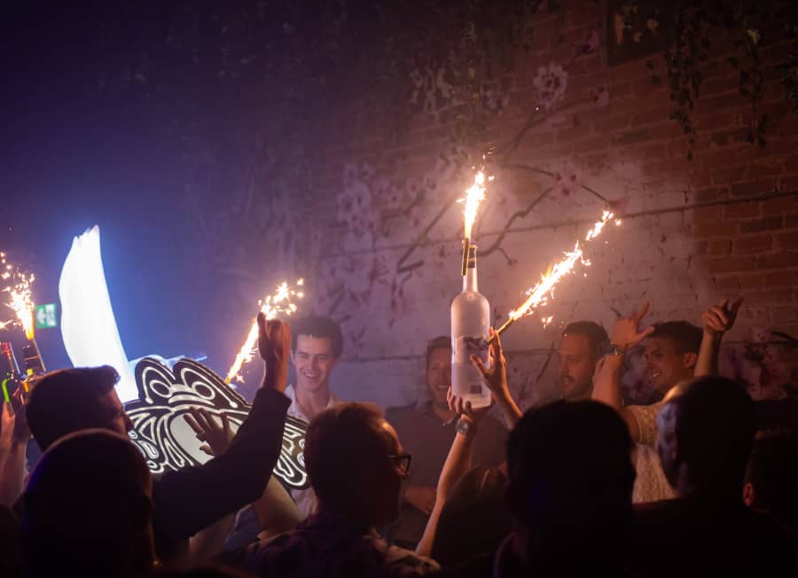 People partying with bottles and lights